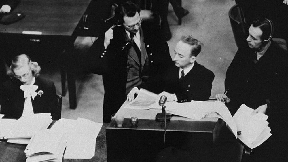 Chief prosecutor Benjamin Ferencz flanked by German defense lawyers, Dr. Friedrich Bergold (right) and Dr. Rudolf Aschenauer (left) at the Nuremberg Trials.